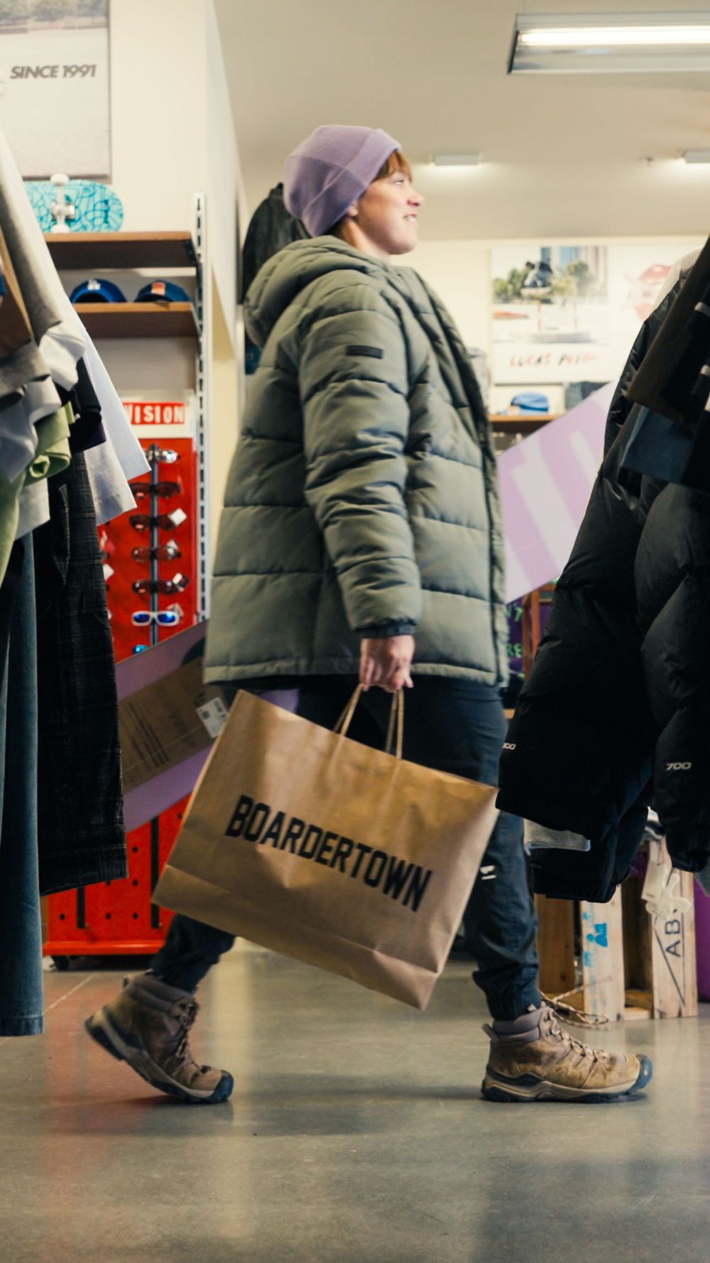 A shopper walking through Five Mile with a Barkers bag