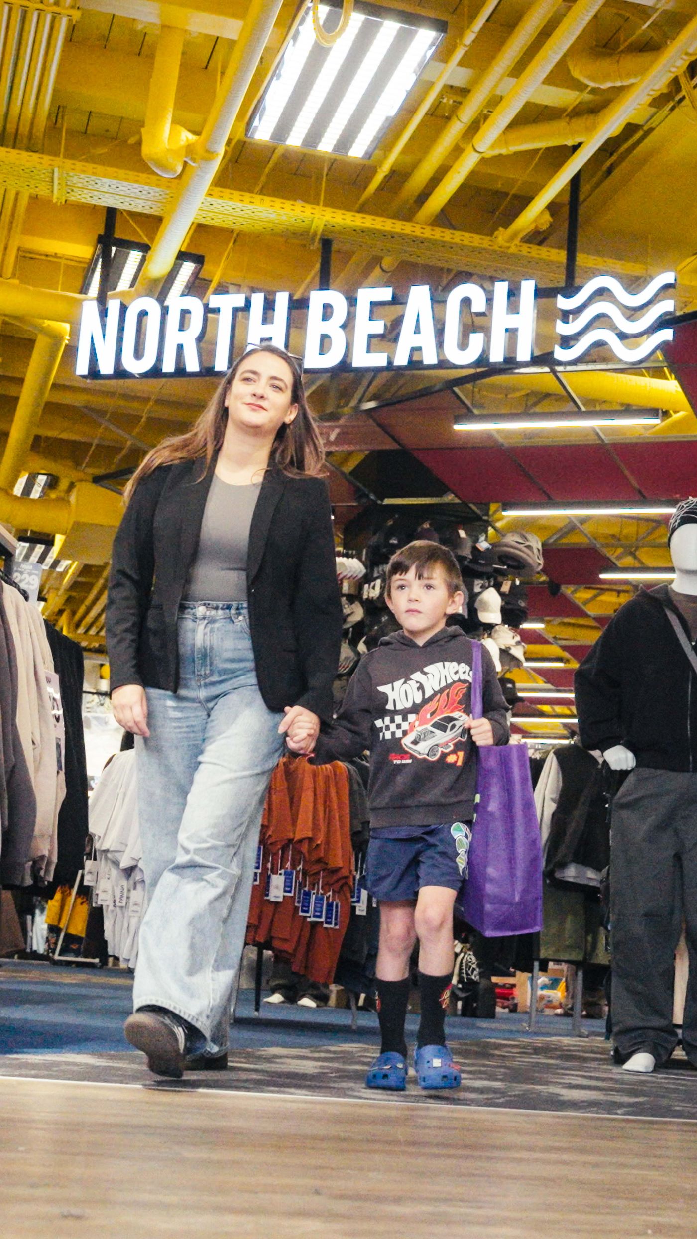 A family walking into North Beach at Five Mile
